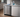 Undercounter stainless steel ice maker installed in a home kitchen with cleaning tools placed on the countertop.